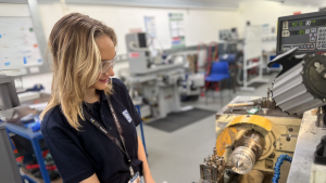 Grace doing work on a machine 